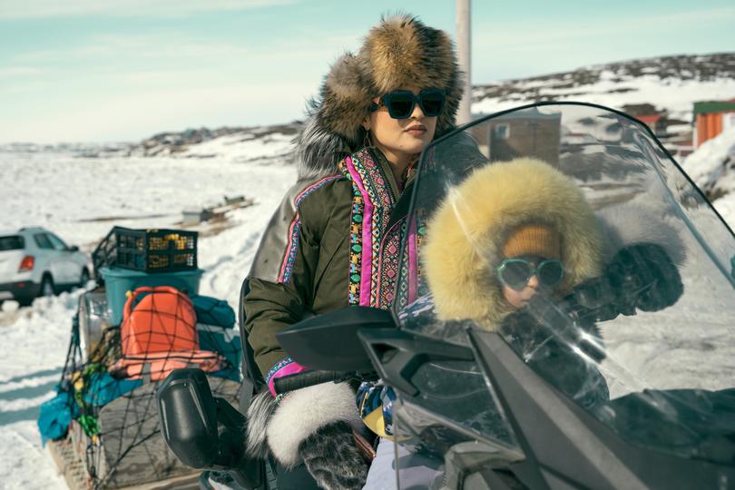 In North of North, Anna Lambe as Siaja and Keira Cooper as her daughter Bun, on a skidoo.