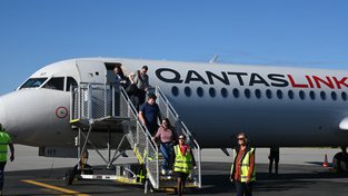 Passengers disembark from the maiden Perth to Busselton flight on the QantasLink F-100.