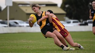 Bunbury's Tara Clifford is tackled by Harvey-Brunswick-Leschenault's Arnya Pickston.